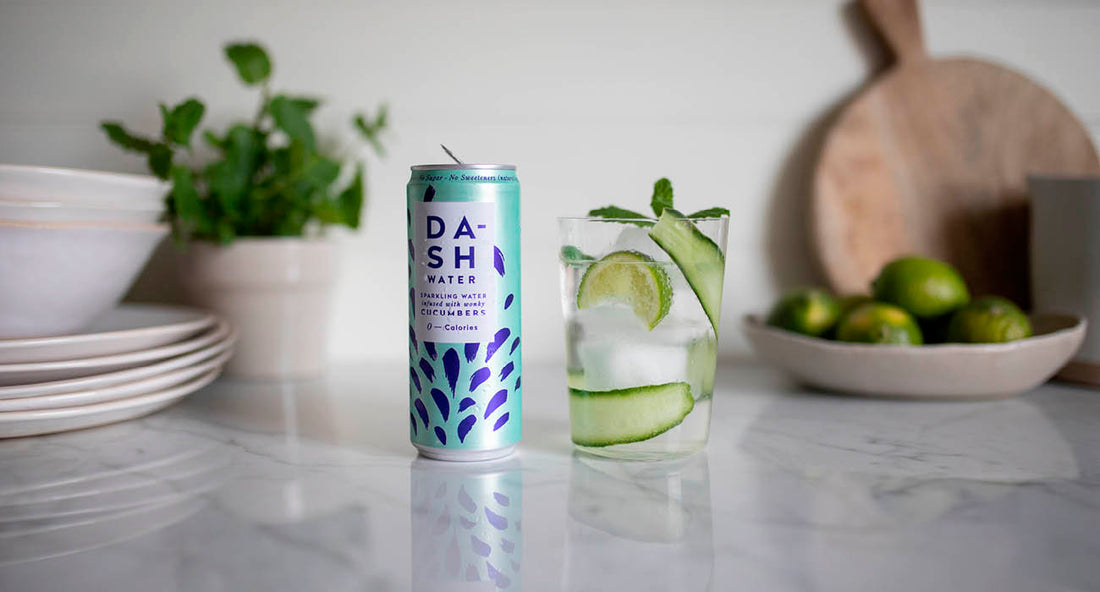 Cucumber mocktail on a worktop with a can of DASH and cucumber peel