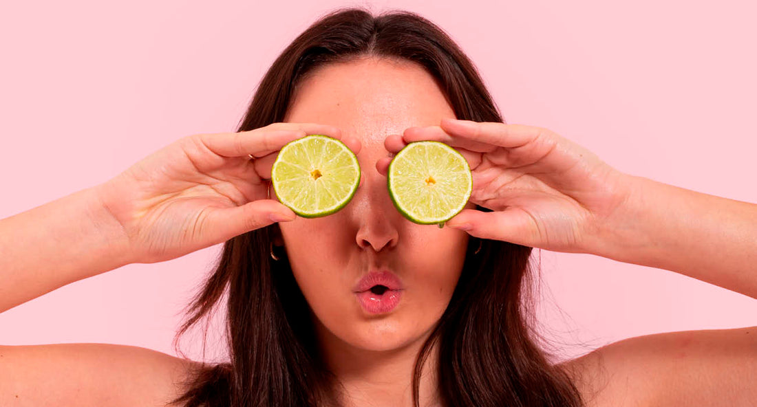 woman holding limes over her eyes 