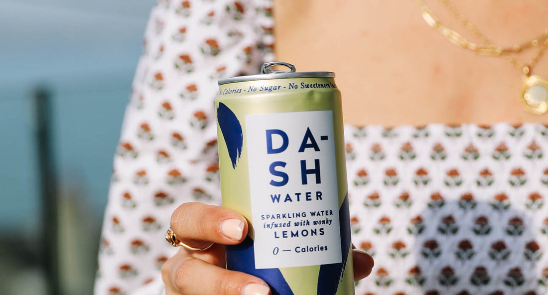 Woman holding can of DASH lemon sparkling water
